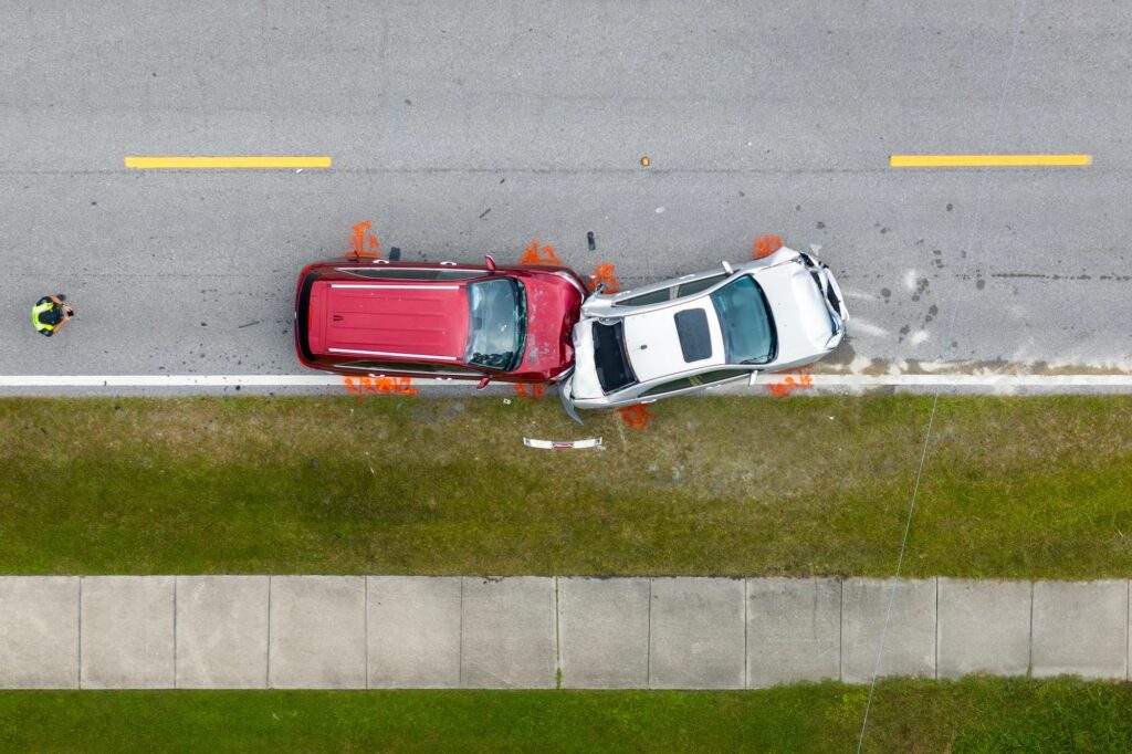 a birds eye view of two cars crashed into eachother on the highway