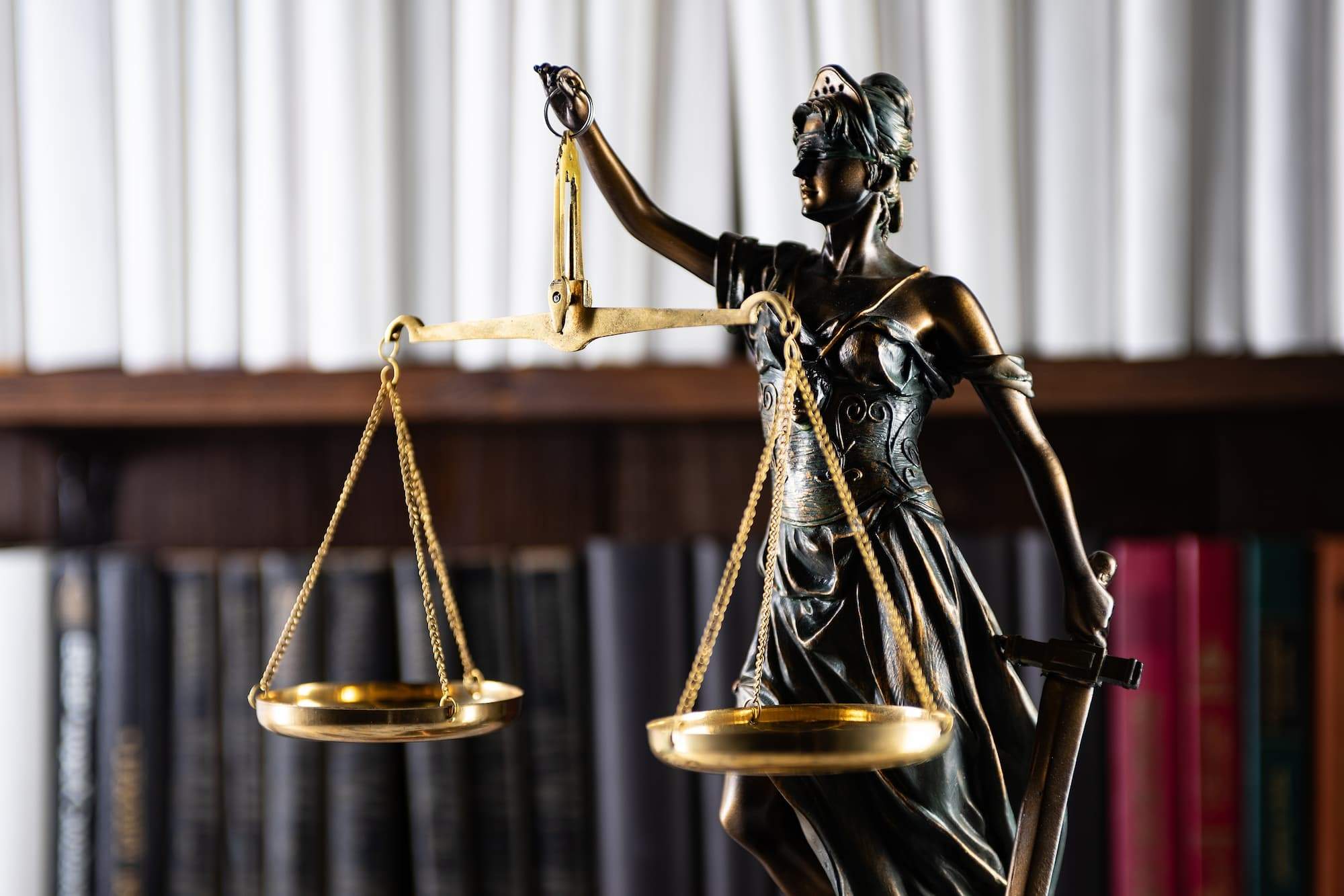 an image of a statue of the lady Justice with a set of scales suspended from one hand